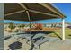 Covered community playground with picnic tables and mature landscaping at 16846 W Molly Ln, Surprise, AZ 85387