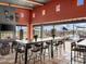 Interior lounge area featuring bar-height seating, stylish light fixtures, and views of the outdoor pool at 17642 W Adams St, Goodyear, AZ 85338