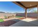 Spacious backyard with desert landscaping, seating area and a covered patio at 17762 W Granite View Dr, Goodyear, AZ 85338