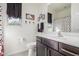 Bathroom with a dark vanity, Mickey Mouse décor, and a polka dot shower curtain at 17762 W Granite View Dr, Goodyear, AZ 85338