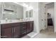 Modern bathroom with double sink vanity, dark wood cabinets and updated tile flooring at 17762 W Granite View Dr, Goodyear, AZ 85338