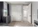 Bedroom featuring carpeted floors, white closet doors, an open door and modern design elements at 17762 W Granite View Dr, Goodyear, AZ 85338