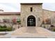 Grand entrance of Presidio Club featuring an arched entrance and professionally landscaped entryway at 17762 W Granite View Dr, Goodyear, AZ 85338