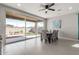 Bright dining area with tile floors, contemporary furniture, and a sliding glass door overlooking the patio at 17762 W Granite View Dr, Goodyear, AZ 85338