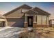 Charming single-story home featuring a well-manicured front yard, a covered porch, and a two-car garage at 17762 W Granite View Dr, Goodyear, AZ 85338