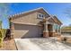 Attractive single-Gathering home with a tidy front yard, stone accents, and an attached two-car garage at 17762 W Granite View Dr, Goodyear, AZ 85338