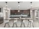 Kitchen island with modern countertops and barstool seating with stylish pendant lighting above at 17762 W Granite View Dr, Goodyear, AZ 85338