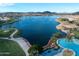 Breathtaking aerial view of the lake, walking paths and community pool amidst a lush landscape at 17762 W Granite View Dr, Goodyear, AZ 85338