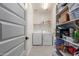 Well-organized pantry with white shelving, gray floors and a stacked washer and dryer at 17762 W Granite View Dr, Goodyear, AZ 85338