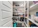 Walk-in pantry with white shelving providing ample storage space for all your food and cooking essentials at 17762 W Granite View Dr, Goodyear, AZ 85338