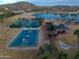 Scenic aerial showcasing basketball, tennis courts and other recreational facilities by a lake at 17762 W Granite View Dr, Goodyear, AZ 85338