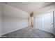 A clean bedroom showcases neutral walls, soft carpeting, and a closet with sliding doors at 17989 W Camino De Oro --, Surprise, AZ 85387