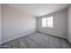 Bright bedroom featuring plush carpeting, a large window, and neutral paint for a calming atmosphere at 17989 W Camino De Oro --, Surprise, AZ 85387