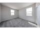 Bright bedroom with dual windows, soft carpeting, and neutral paint, creating a relaxing retreat at 17989 W Camino De Oro --, Surprise, AZ 85387