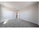 Neutral bedroom featuring gray carpet, white trim, and a closet with sliding doors at 17989 W Camino De Oro --, Surprise, AZ 85387