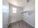 Laundry room featuring tile flooring, window, and built-in shelving at 17989 W Camino De Oro --, Surprise, AZ 85387