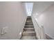 Lit carpeted staircase features a white handrail, offering a clear path to the upper floors at 17989 W Camino De Oro --, Surprise, AZ 85387
