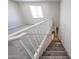 Carpeted staircase with white banister guides you to a cozy landing with natural light at 17989 W Camino De Oro --, Surprise, AZ 85387
