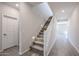 Bright, carpeted staircase features recessed lighting and white railing, leading to the upper level at 17989 W Camino De Oro --, Surprise, AZ 85387