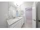 Bright bathroom featuring a double vanity with a solid surface countertop at 17996 W Camino De Oro --, Surprise, AZ 85387