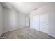 This bedroom features neutral carpeting, a bright white wall color, and a closet at 17996 W Camino De Oro --, Surprise, AZ 85387