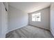 Bright bedroom with neutral carpet, trim and paint and a window at 17996 W Camino De Oro --, Surprise, AZ 85387