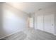 This bedroom has neutral carpeting, paint and trim, and a closet at 17996 W Camino De Oro --, Surprise, AZ 85387