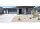 Inviting single-story home featuring a stone-accented porch and low-maintenance desert landscaping at 17996 W Camino De Oro --, Surprise, AZ 85387