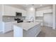 Bright kitchen features white cabinets, gray backsplash, stainless appliances, and granite countertops at 17996 W Camino De Oro --, Surprise, AZ 85387