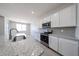 Bright kitchen features white cabinets, gray backsplash, stainless appliances, and granite countertops at 17996 W Camino De Oro --, Surprise, AZ 85387