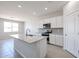 Bright kitchen features white cabinets, gray backsplash, stainless appliances, and granite countertops at 17996 W Camino De Oro --, Surprise, AZ 85387