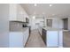 Bright kitchen features white cabinets, gray backsplash, stainless appliances, and granite countertops at 17996 W Camino De Oro --, Surprise, AZ 85387