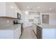 Bright kitchen features white cabinets, gray backsplash, stainless appliances, and granite countertops at 17996 W Camino De Oro --, Surprise, AZ 85387
