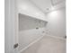 This clean, functional laundry room has tiled floors and storage shelving at 17996 W Camino De Oro --, Surprise, AZ 85387
