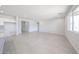 Open-concept living area featuring tile flooring, neutral walls, and access to other rooms at 17996 W Camino De Oro --, Surprise, AZ 85387