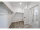 Walk-in closet with carpeted floor and built-in shelving with door to bathroom at 17996 W Camino De Oro --, Surprise, AZ 85387