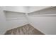 Walk-in closet with carpeted floor and built-in shelving at 17996 W Camino De Oro --, Surprise, AZ 85387