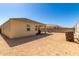 View of the backyard showcasing the exterior of the home with a desert landscape at 18800 W Madison St, Buckeye, AZ 85326