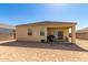 Spacious backyard showcasing a covered patio ideal for outdoor entertaining and relaxation at 18800 W Madison St, Buckeye, AZ 85326