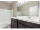 Bathroom has single sink vanity, dark wood cabinets, and a tub/shower combo at 18800 W Madison St, Buckeye, AZ 85326