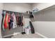 Walk-in closet has ample hanging space on multiple rods and shelves for organized storage at 18800 W Madison St, Buckeye, AZ 85326