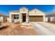 Charming single-story home with a two-car garage and desert landscaping at 18800 W Madison St, Buckeye, AZ 85326