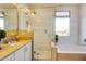 Clean and modern bathroom with a glass shower, soaking tub, and a window with natural light at 1940 W Kinfield Trl, Phoenix, AZ 85085