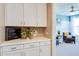 Charming butler's pantry with white cabinets, a quartz countertop, and view to bedroom beyond at 1940 W Kinfield Trl, Phoenix, AZ 85085