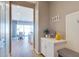 Welcoming entryway with white cabinets, a bench, and a view into the dining area at 1940 W Kinfield Trl, Phoenix, AZ 85085