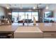 Bright kitchen featuring a farmhouse sink, modern faucet, and a view of the open-concept living and dining area at 1940 W Kinfield Trl, Phoenix, AZ 85085