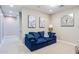 Relaxing living room featuring a plush blue sofa, stylish art, and neutral decor at 1940 W Kinfield Trl, Phoenix, AZ 85085