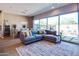 Stylish living room with a large sectional, an area rug, and expansive glass sliding doors to the patio at 1940 W Kinfield Trl, Phoenix, AZ 85085