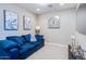 Cozy living room with a comfortable blue sofa, decorative artwork, and modern lighting fixtures at 1940 W Kinfield Trl, Phoenix, AZ 85085