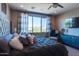 Comfortable main bedroom with a ceiling fan, serene decor, and views of the surrounding landscape at 1940 W Kinfield Trl, Phoenix, AZ 85085